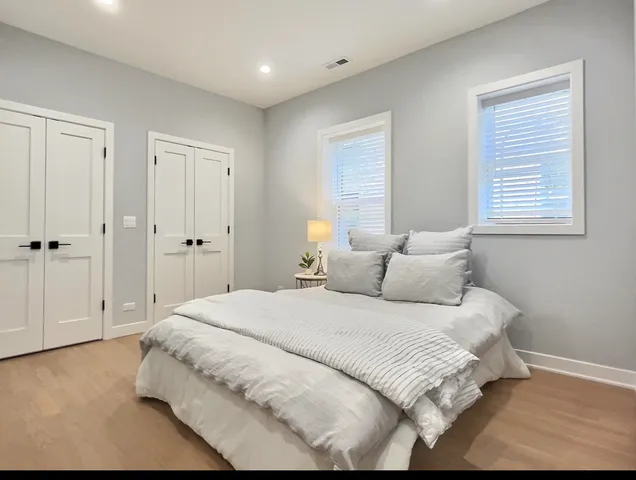 a bathroom with a double vanity sink toilet and shower