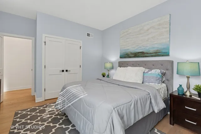 a bedroom with a bed and glass window