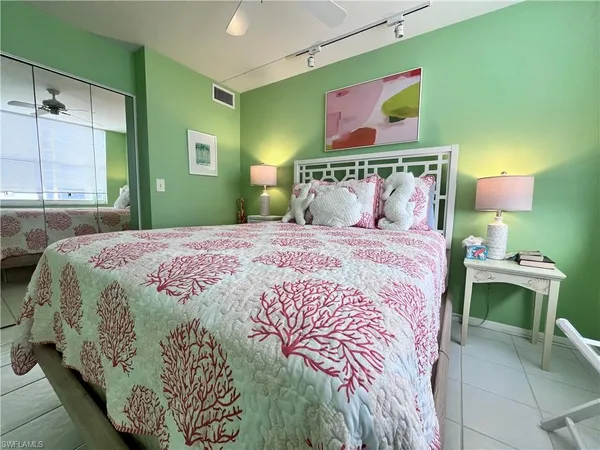 a bedroom with a bed and a painting on the wall