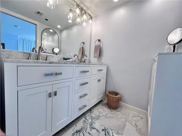 a bathroom with a double vanity sink and a toilet