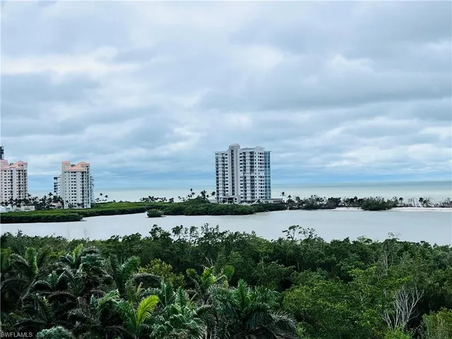 a view of a city with lake and tall building in the back
