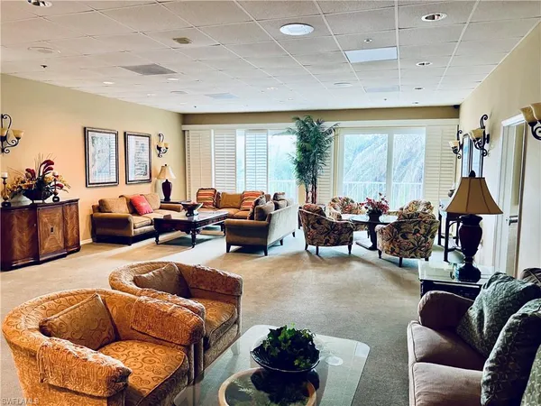 a living room with furniture a couch and a chandelier