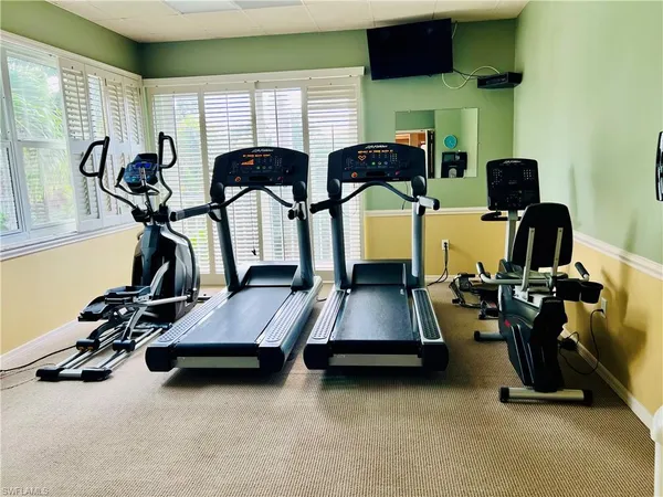 a room with gym equipment and a large window