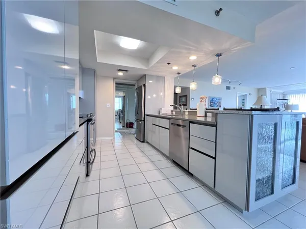 a kitchen with stainless steel appliances granite countertop refrigerator sink and microwave