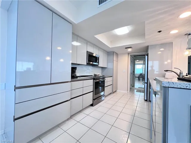 a large kitchen with a stove a sink dishwasher and a refrigerator