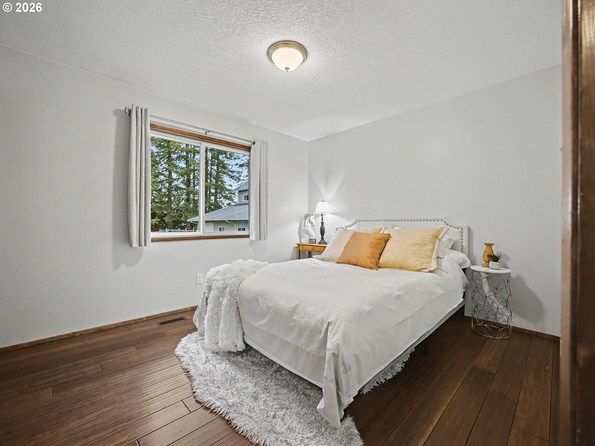 38100 Southeast Trubel Road Sandy, OR 97055 - Photo 20 of 48 a bedroom with a bed and wooden floor