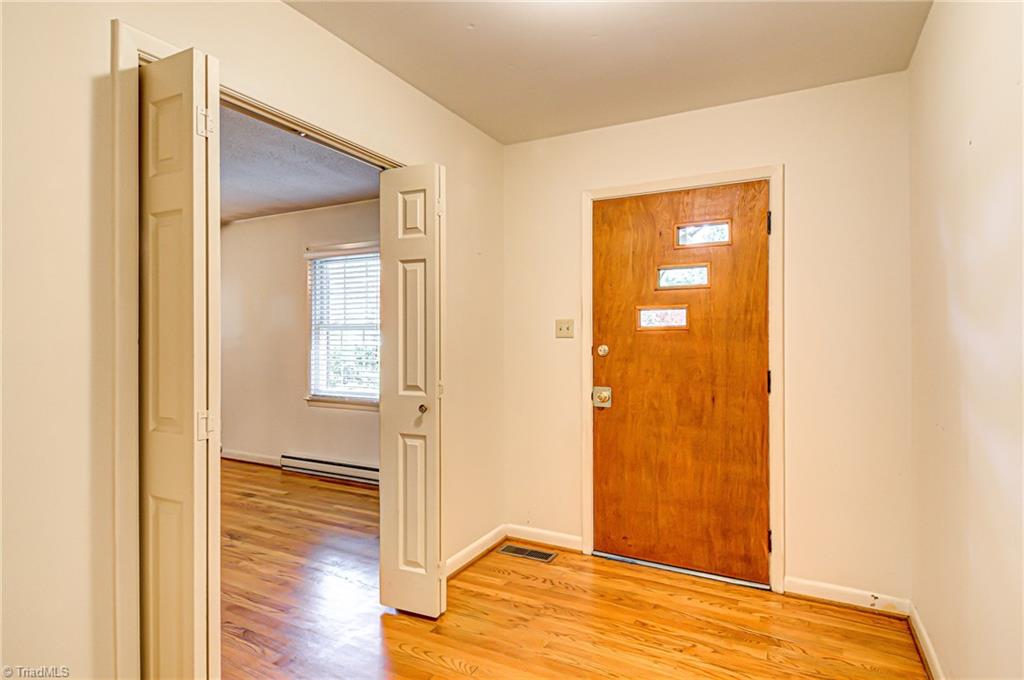 3915 Frazier Road Greensboro, NC 27407 - Photo 3 of 25 Nice open front door entry with hardwoods.