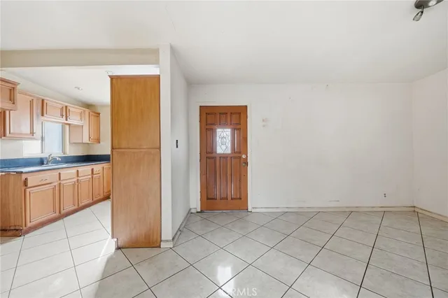 a view of a kitchen with a sink and a refrigerator