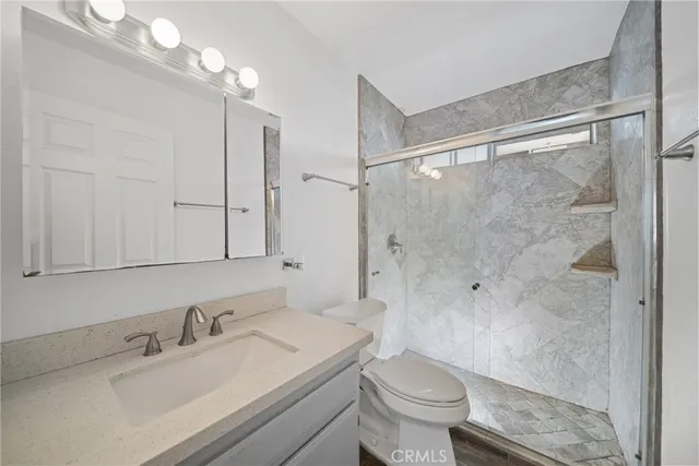 a bathroom with a sink toilet and shower