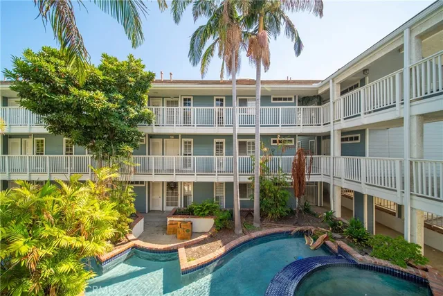 a view of a house with swimming pool and sitting area