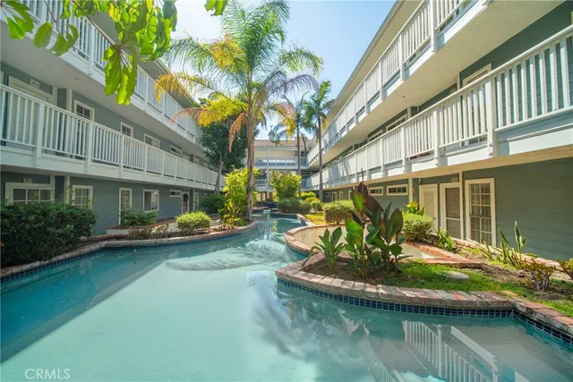 a view of a house with swimming pool next to a yard