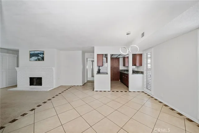 a view of kitchen with furniture and refrigerator