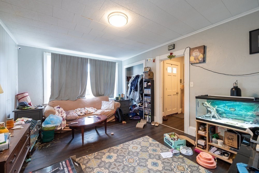 54-56 Stetson Street Whitman, MA 02382 - Photo 18 of 42 a living room with furniture and a window