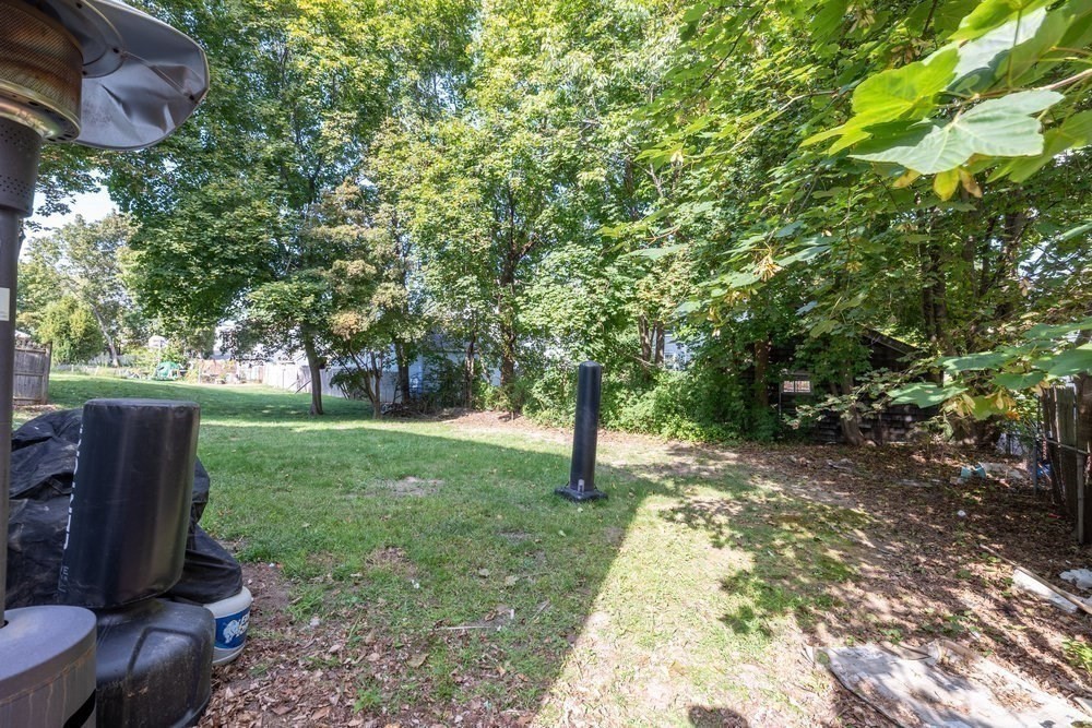 54-56 Stetson Street Whitman, MA 02382 - Photo 32 of 42 a view of a backyard with large trees and a barn