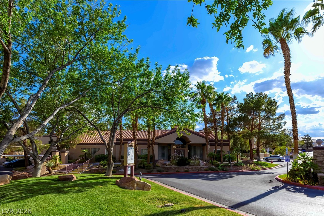 9325 West Desert Inn Road, Unit 260 Las Vegas, NV 89117 - Photo 2 of 4 Lush landscaping and mature trees frame this appealing community entrance with a welcoming facade.