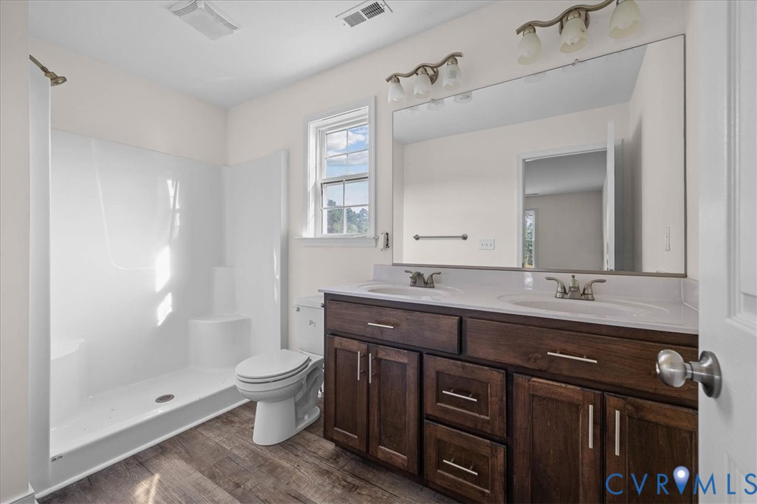 11325 Webb Road Disputanta, VA 23842 - Photo 19 of 32 Full bathroom with dark wood finished floors, doub