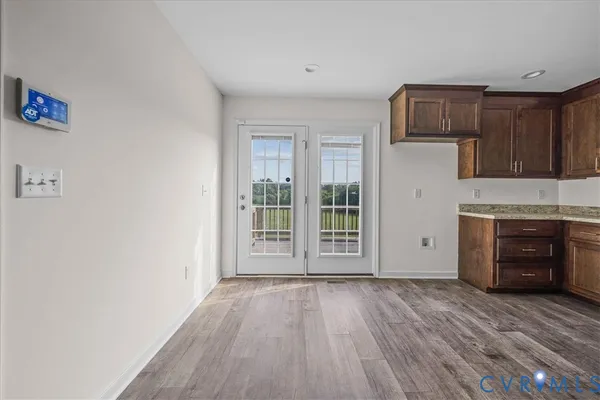 a kitchen with stainless steel appliances kitchen island wooden cabinets and granite counter tops