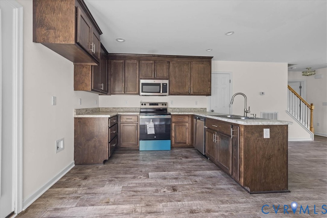 11325 Webb Road Disputanta, VA 23842 - Photo 9 of 32 Kitchen featuring dark brown cabinetry, appliances