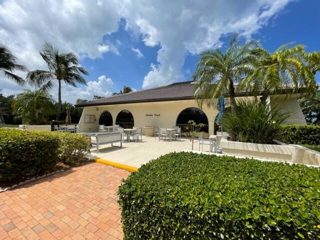 500 Ocean Trail Way, Unit 204 Jupiter, FL 33477 - Photo 28 of 40 a front view of a house with swimming pool and porch with furniture