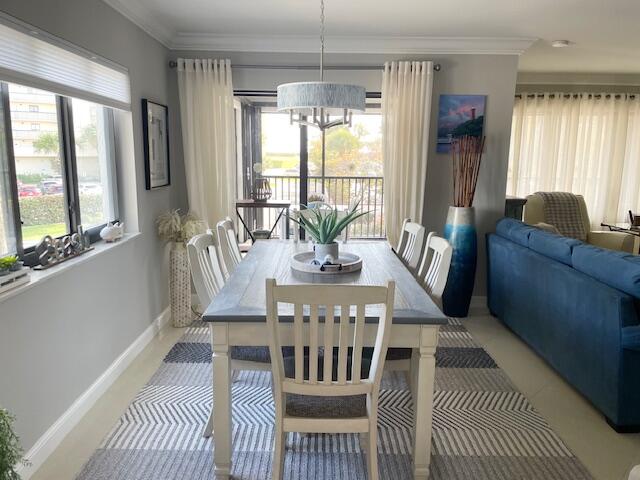 500 Ocean Trail Way, Unit 204 Jupiter, FL 33477 - Photo 6 of 40 a view of a dining room with furniture a chandelier and wooden floor