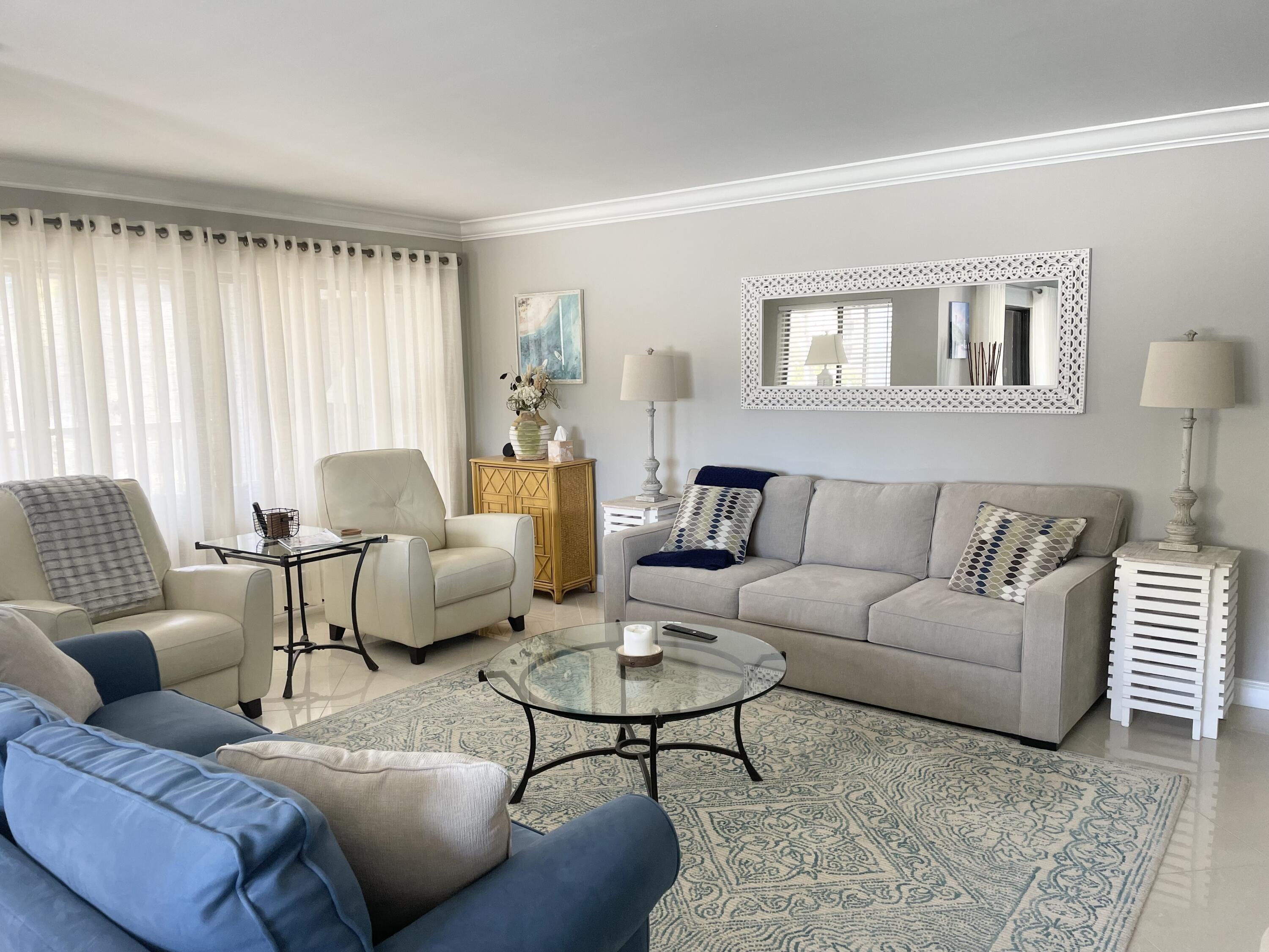500 Ocean Trail Way, Unit 204 Jupiter, FL 33477 - Photo 8 of 40 a living room with furniture and a large window