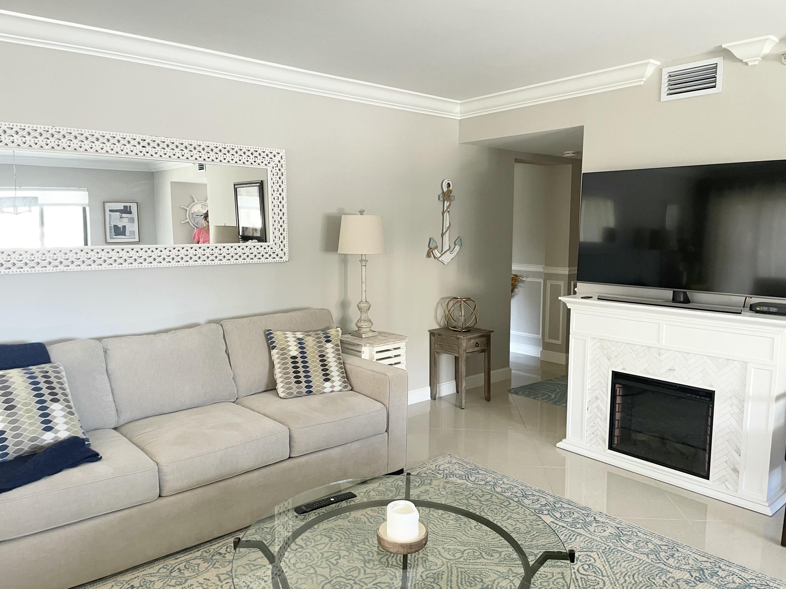 500 Ocean Trail Way, Unit 204 Jupiter, FL 33477 - Photo 9 of 40 a living room with furniture and a fireplace