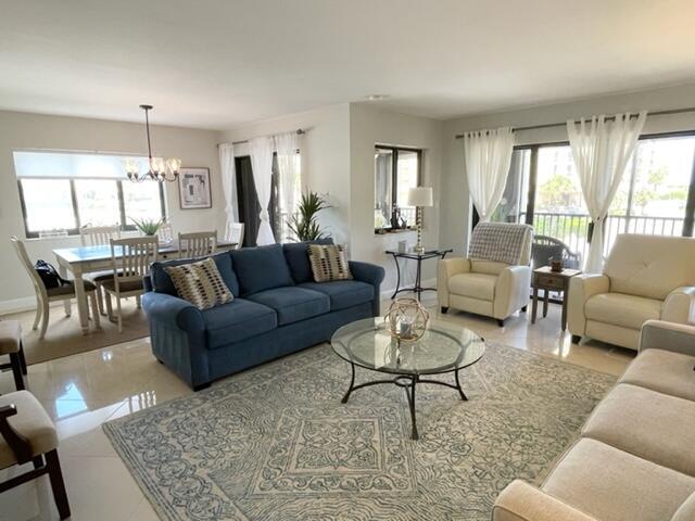 500 Ocean Trail Way, Unit 204 Jupiter, FL 33477 - Photo 10 of 40 a living room with furniture potted plant and a large window