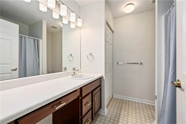 a bathroom with a sink a mirror and a shower
