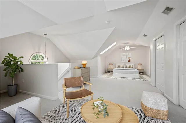 a living room with furniture and a potted plant