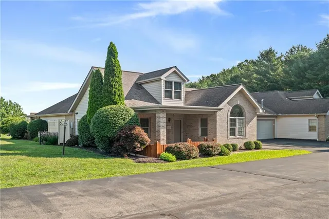 a front view of house with yard and green space