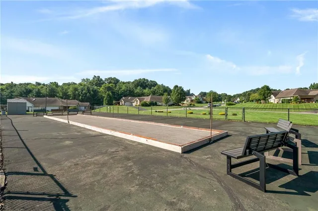 a view of a park with couches and table and chairs