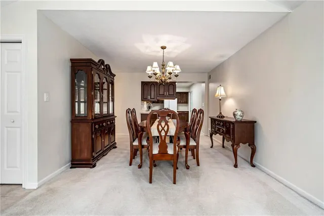 a view of a dining room with furniture and chandelier