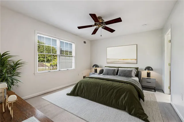 a bedroom with a large bed and a window