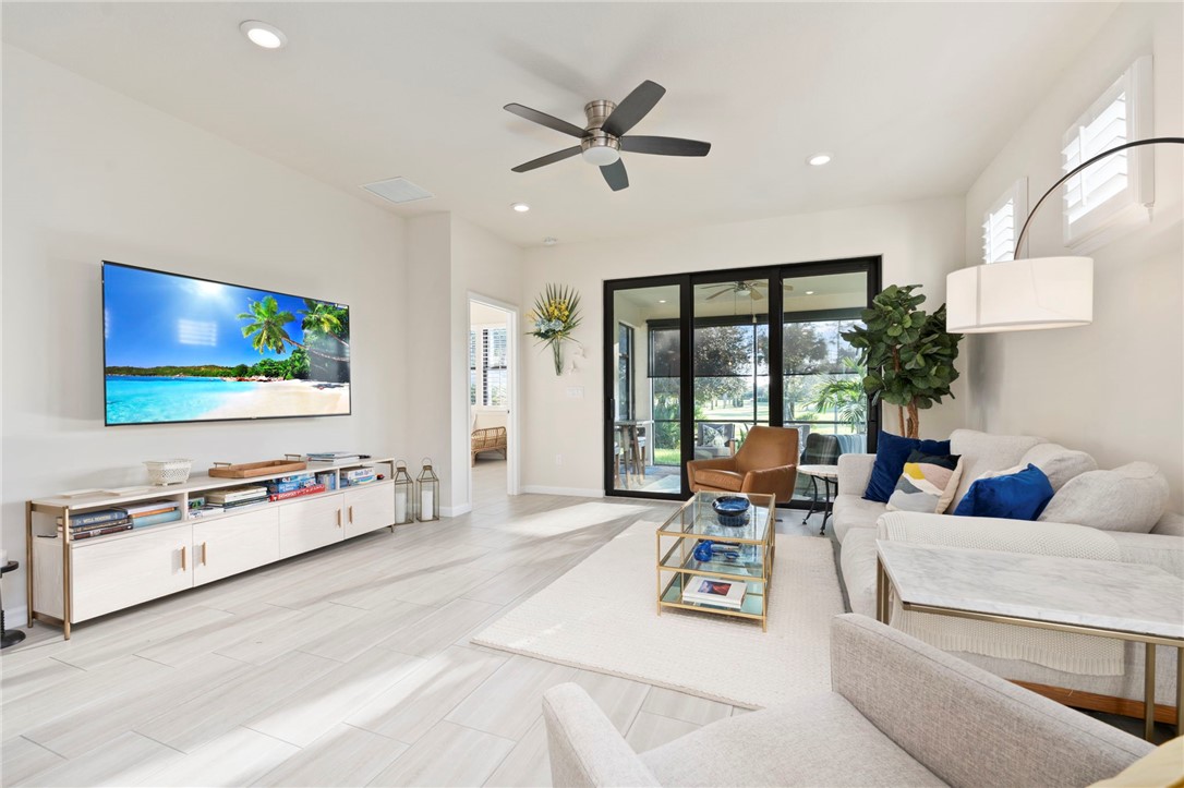 5208 Unity Square Vero Beach, FL 32967 - Photo 15 of 34 a living room with furniture and a flat screen tv