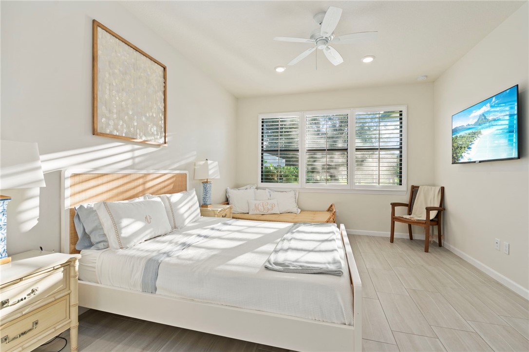 5208 Unity Square Vero Beach, FL 32967 - Photo 17 of 34 a bedroom with a bed and a table in it with window