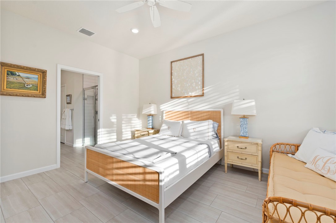 5208 Unity Square Vero Beach, FL 32967 - Photo 19 of 34 a bedroom with a bed and a night stand