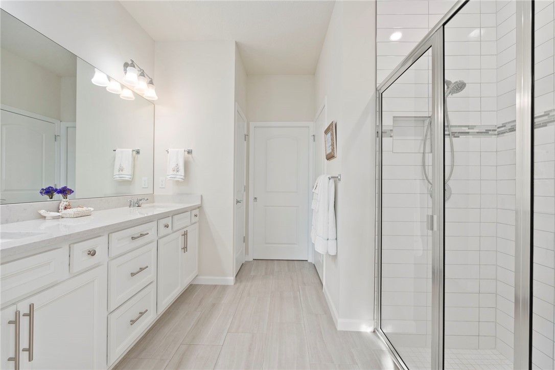 5208 Unity Square Vero Beach, FL 32967 - Photo 21 of 34 a bathroom with a double vanity sink and a mirror