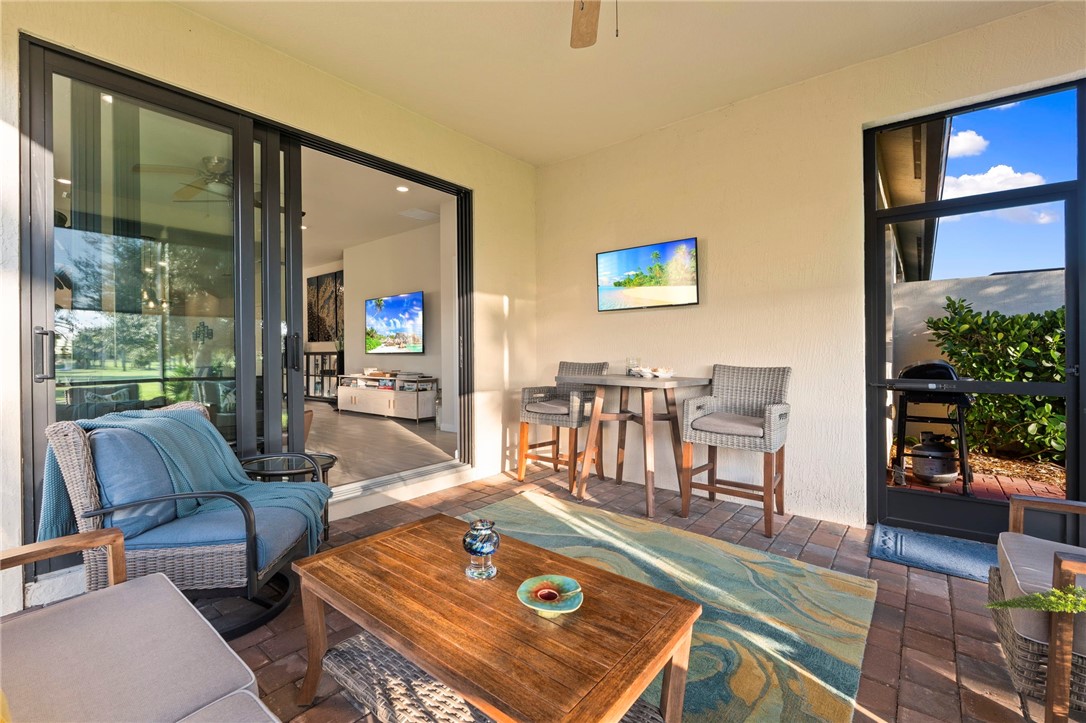 5208 Unity Square Vero Beach, FL 32967 - Photo 27 of 34 a living room with furniture and a floor to ceiling window