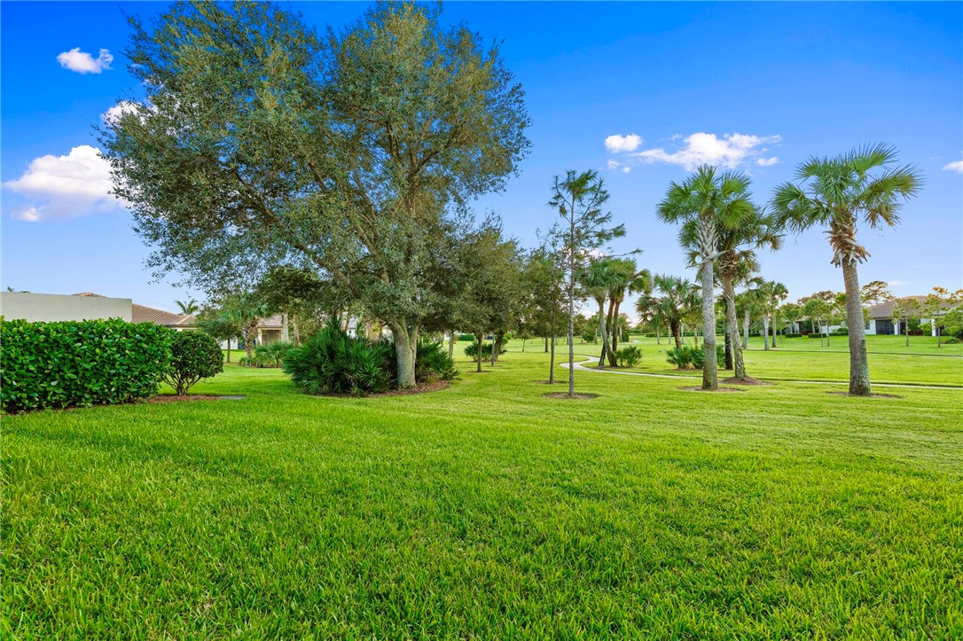 5208 Unity Square Vero Beach, FL 32967 - Photo 31 of 34 a grassy field with lots of trees