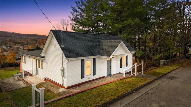 a view of a house with wooden fence