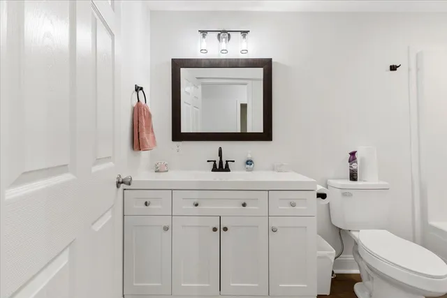 a kitchen with granite countertop a sink stainless steel appliances and white cabinets
