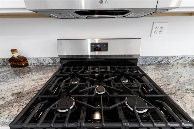 a bathroom with a sink double vanity granite and a toilet