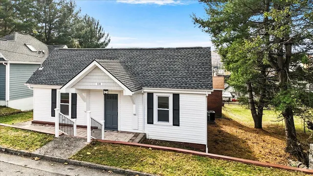 a view of a house with wooden fence