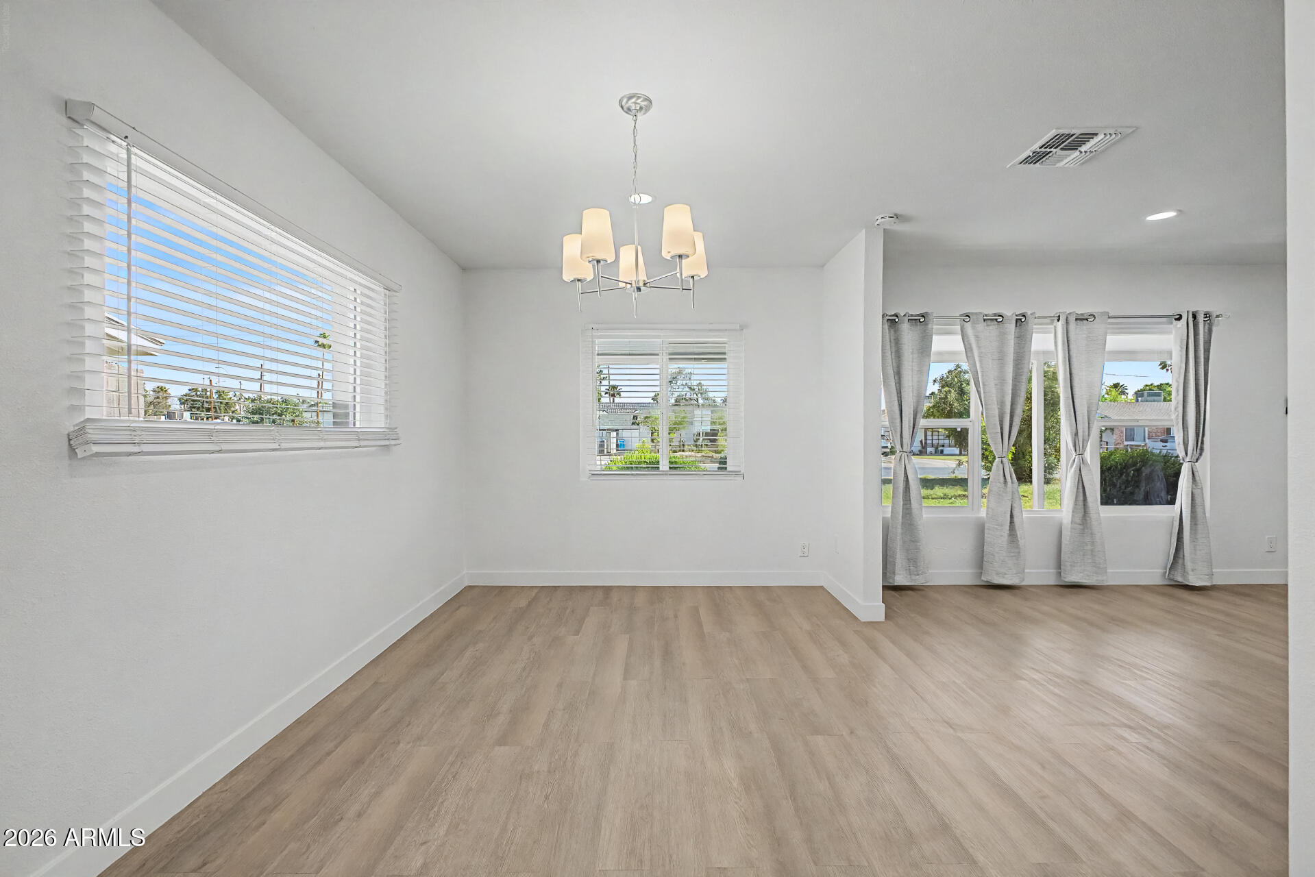 532 East Cheery Lynn Road Phoenix, AZ 85014 - Photo 11 of 37 a view of an empty room with wooden floor and a window