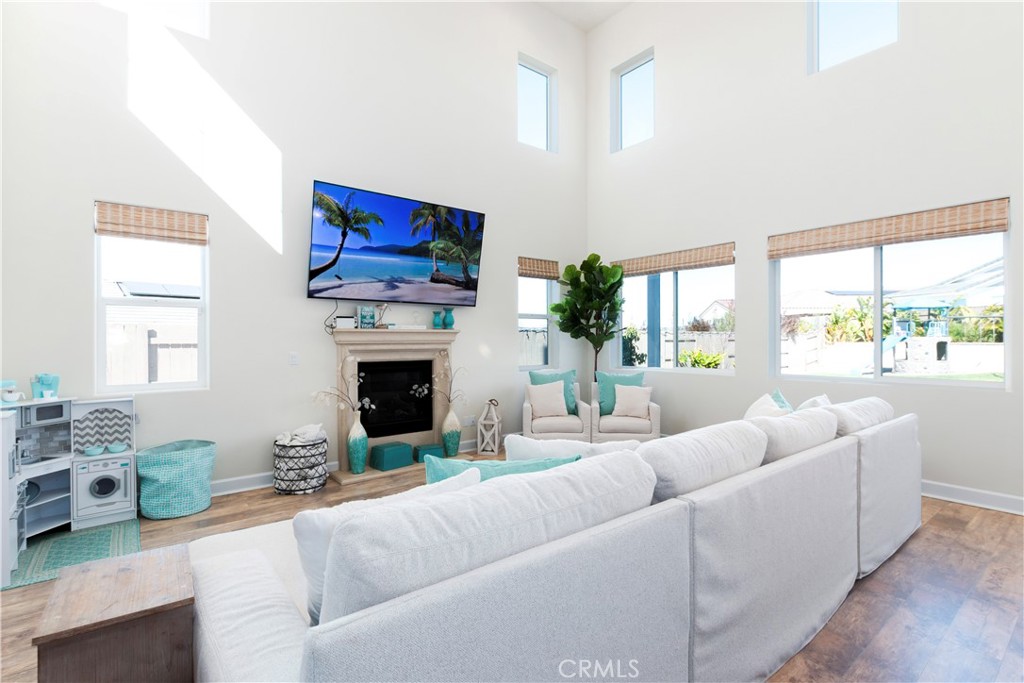 1275 Grand Meadow Way Santa Maria, CA 93455 - Photo 30 of 66 a living room with furniture a fireplace and a large window