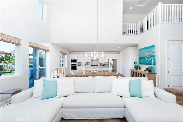 a living room with furniture a window and wooden floor