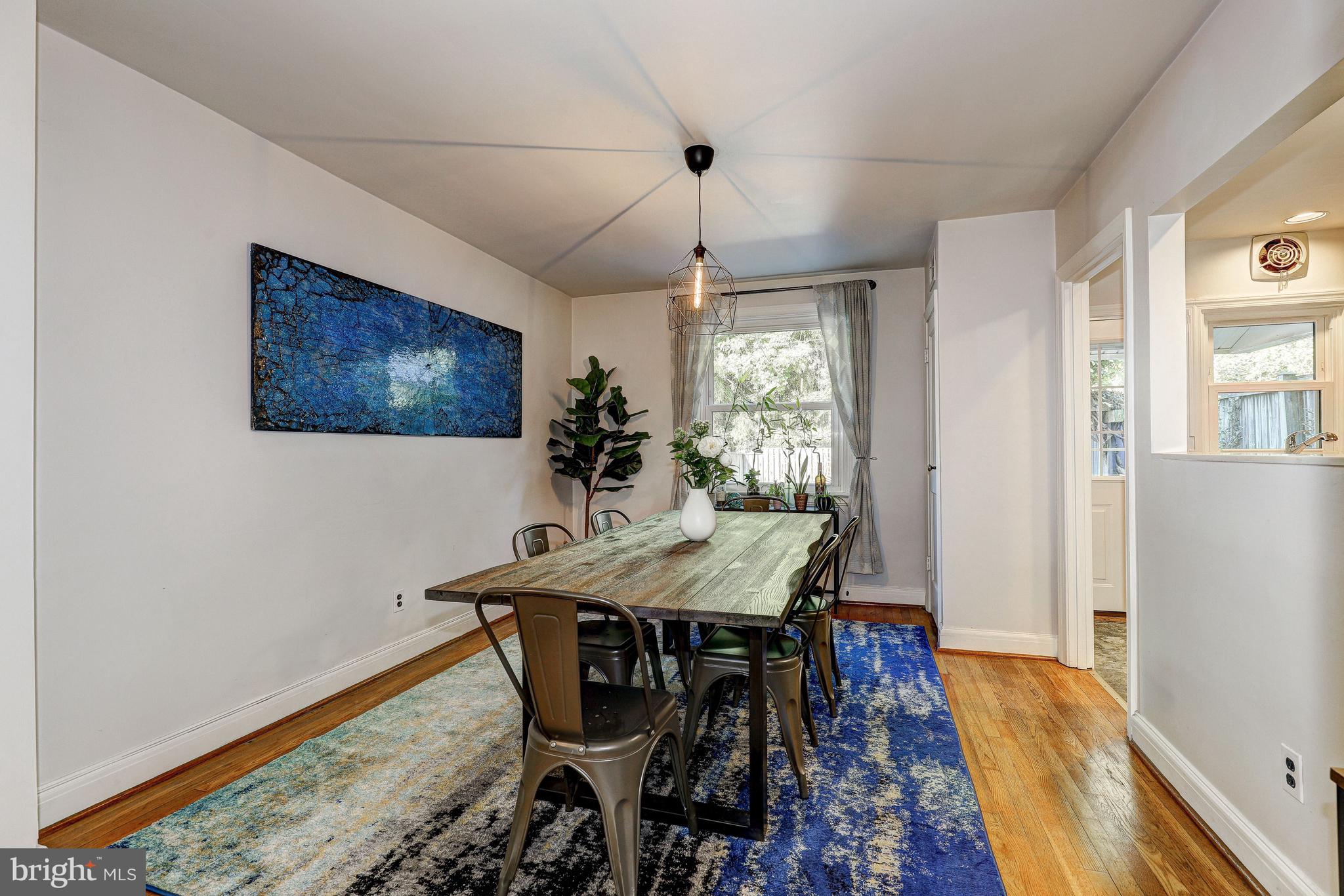 3908 Rexmere Road Baltimore, MD 21218 - Photo 12 of 39 a view of a dining room with furniture window and wooden floor