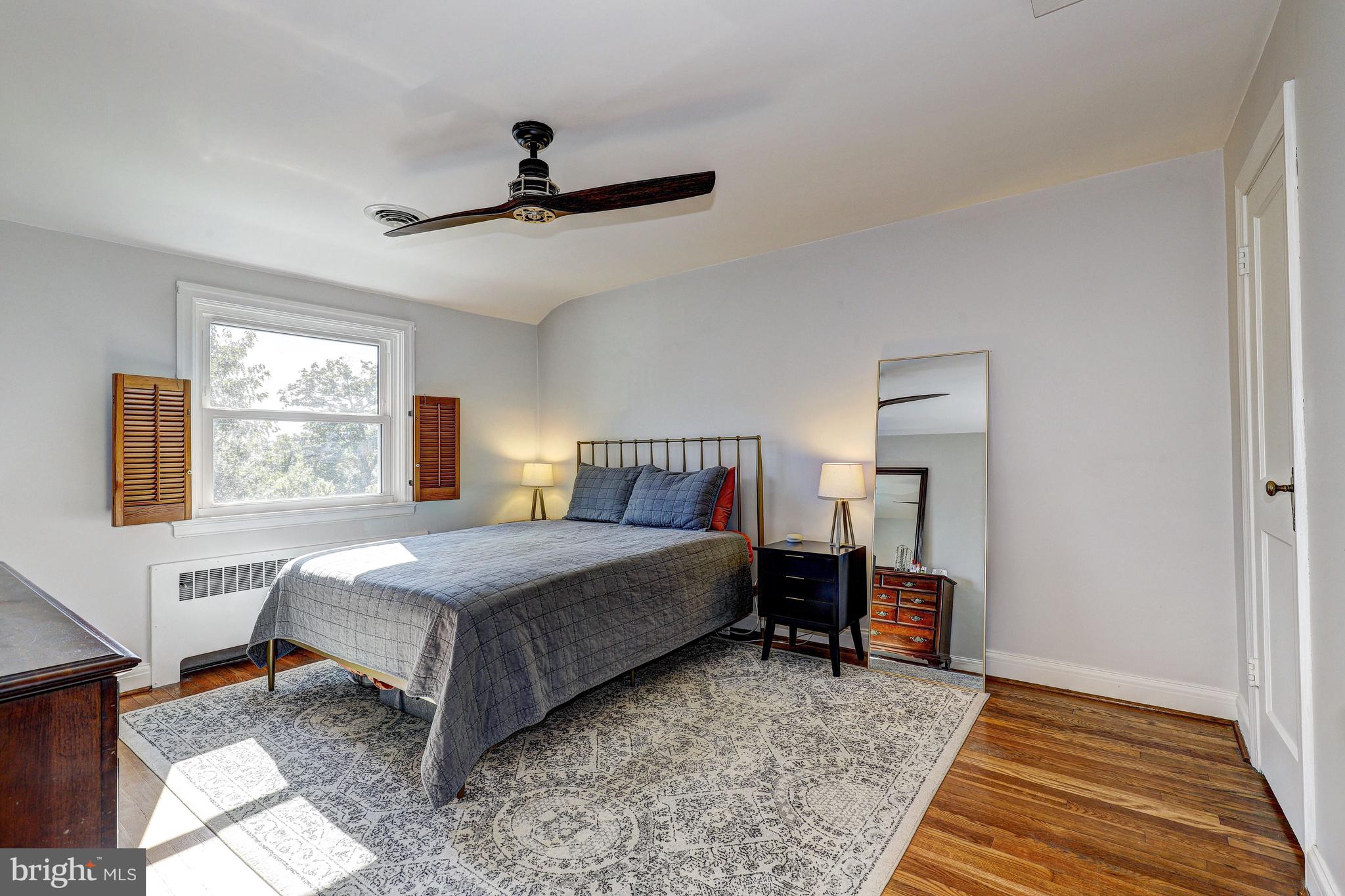 3908 Rexmere Road Baltimore, MD 21218 - Photo 16 of 39 a bedroom with a bed and wooden floor