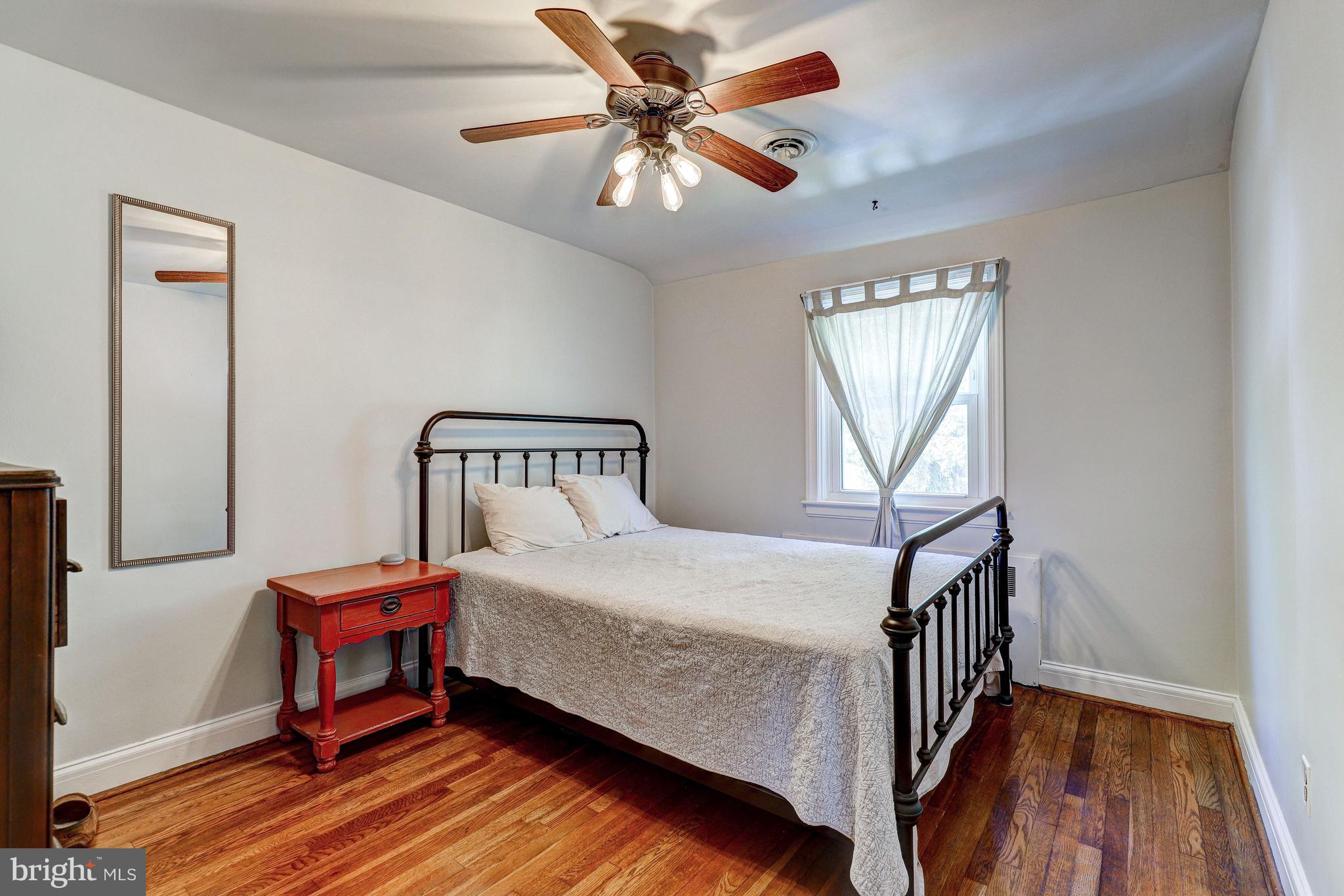 3908 Rexmere Road Baltimore, MD 21218 - Photo 18 of 39 a bedroom with a bed and a chandelier
