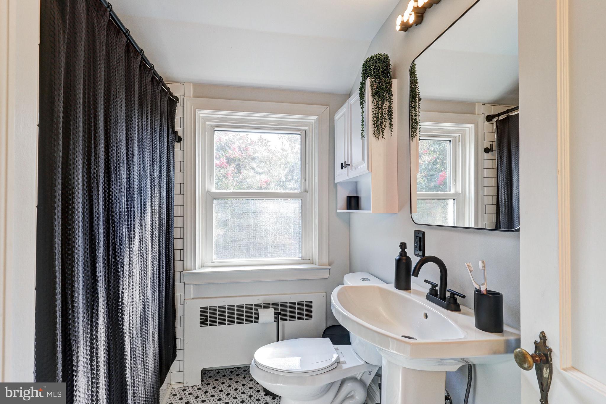 3908 Rexmere Road Baltimore, MD 21218 - Photo 20 of 39 a bathroom with a sink a toilet and a mirror